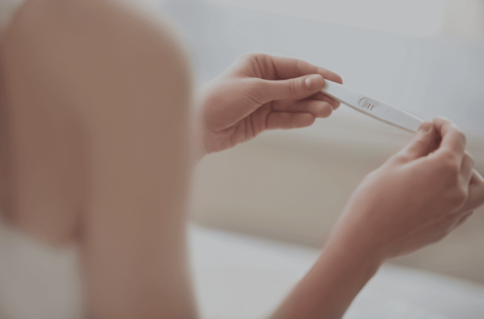 Birth mother checks a pregnancy test