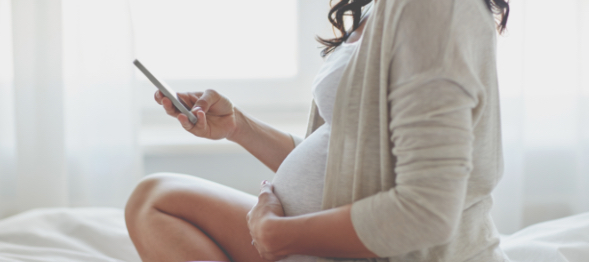 Pregnant woman using cell phone