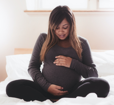 Expectant mother considering adoption options during her unplanned pregnancy.