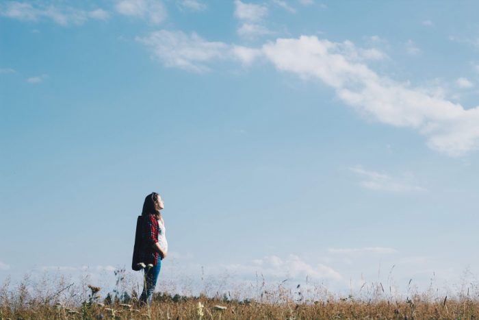 pregnant woman looking up into the sky