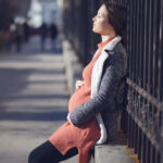 pregnant birth mother sitting outside